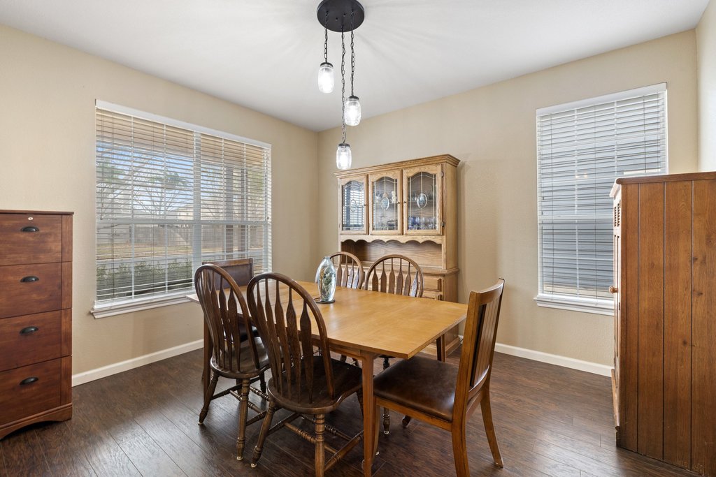 207 Rosedale Boulevard Georgetown, TX 78628 - Photo 13 of 31 a view of a dining room with furniture window and wooden floor
