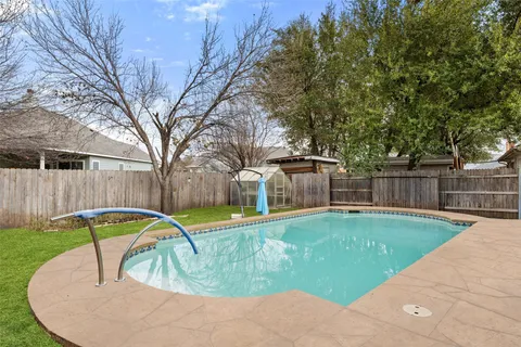 a view of a backyard with swimming pool