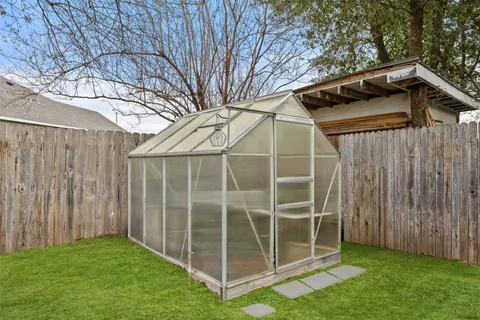 a view of a backyard with a large tree