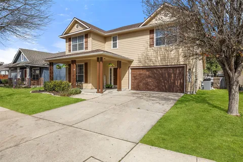 a front view of a house with a garden and yard