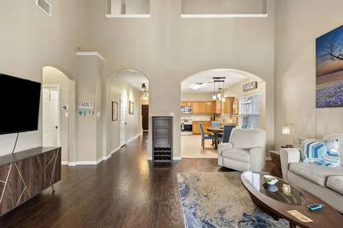 a living room with furniture a flat screen tv and a fireplace