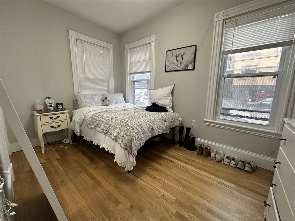 68 L Street, Unit 1 Boston, MA 02127 - Photo 6 of 12 a bedroom with a bed and a window