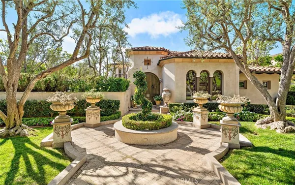 a view of a house with patio and a garden