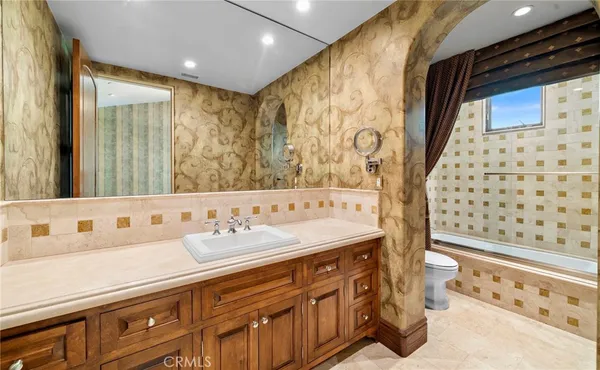 a bathroom with a sink a toilet and mirror