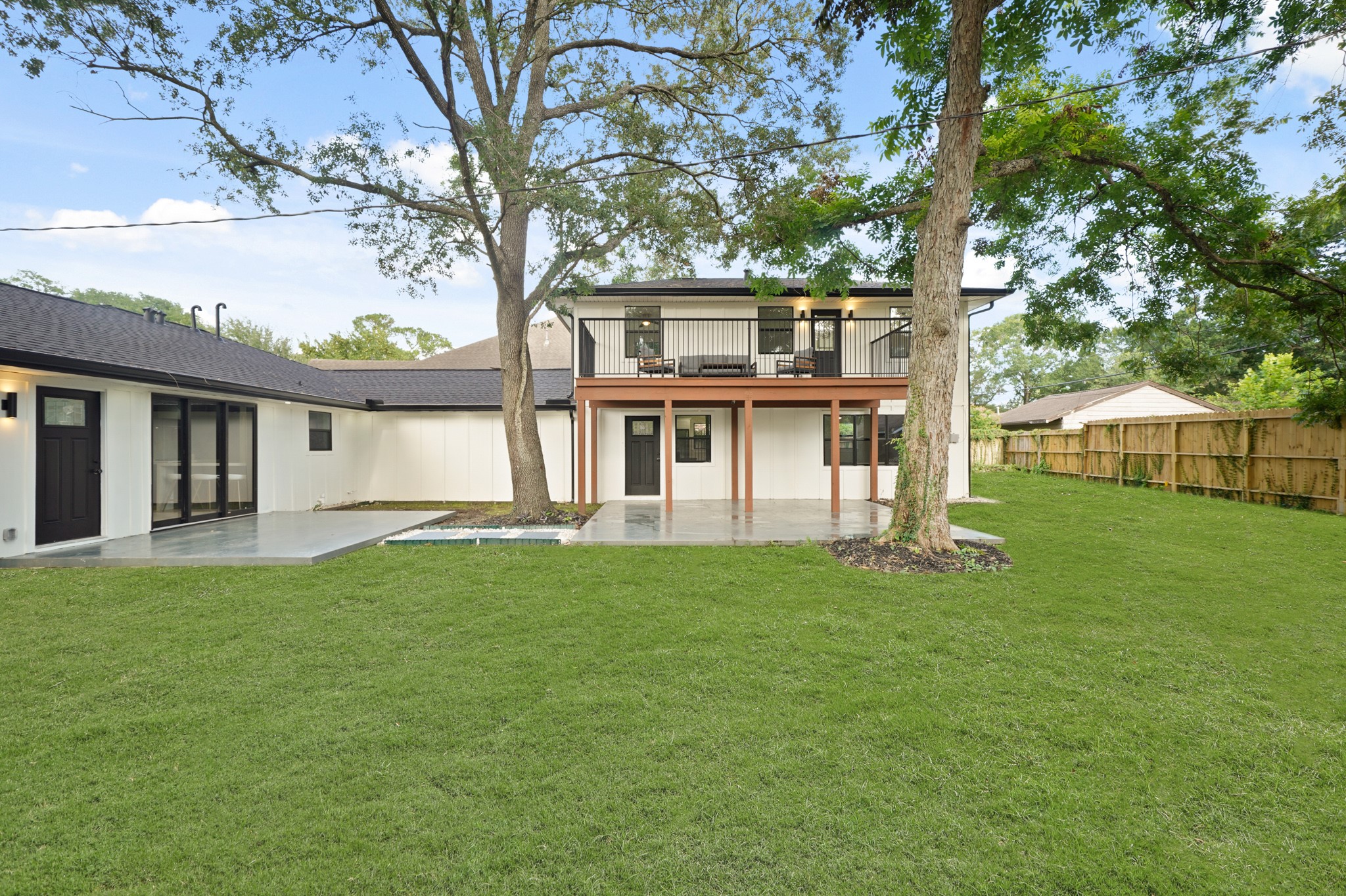 4813 Hummingbird Street Houston, TX 77035 - Photo 35 of 50 On your Left, The Outdoor Living Area (Approximately 15'5" x 11'6") features Large Format Grey Tile and is accessed through Triple Glass Doors from the Dining Area.