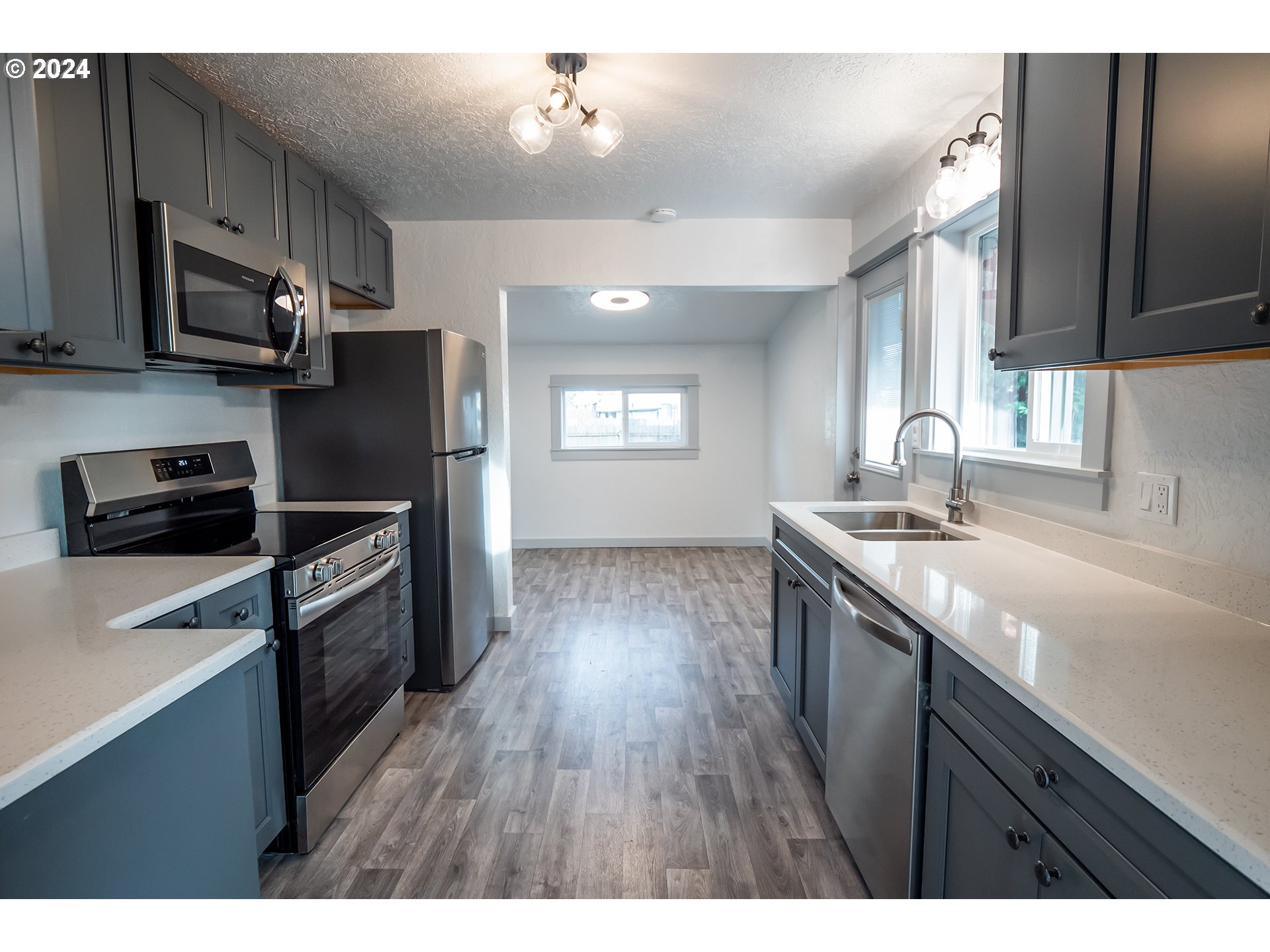 930 Elm Street Junction City, OR 97448 - Photo 2 of 33 a kitchen with stainless steel appliances granite countertop a sink stove and refrigerator