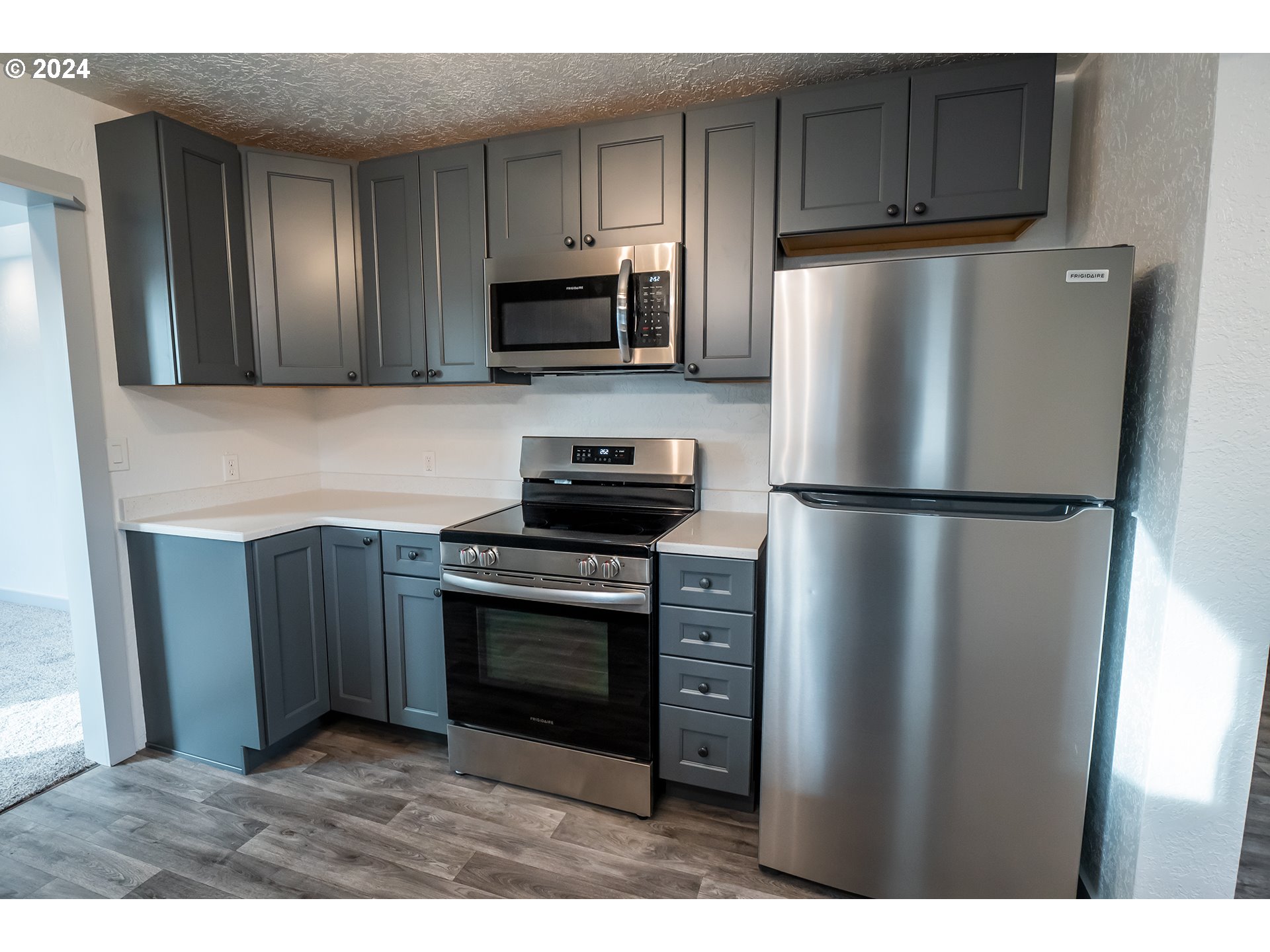 930 Elm Street Junction City, OR 97448 - Photo 4 of 33 a kitchen with stainless steel appliances granite countertop a refrigerator stove and microwave