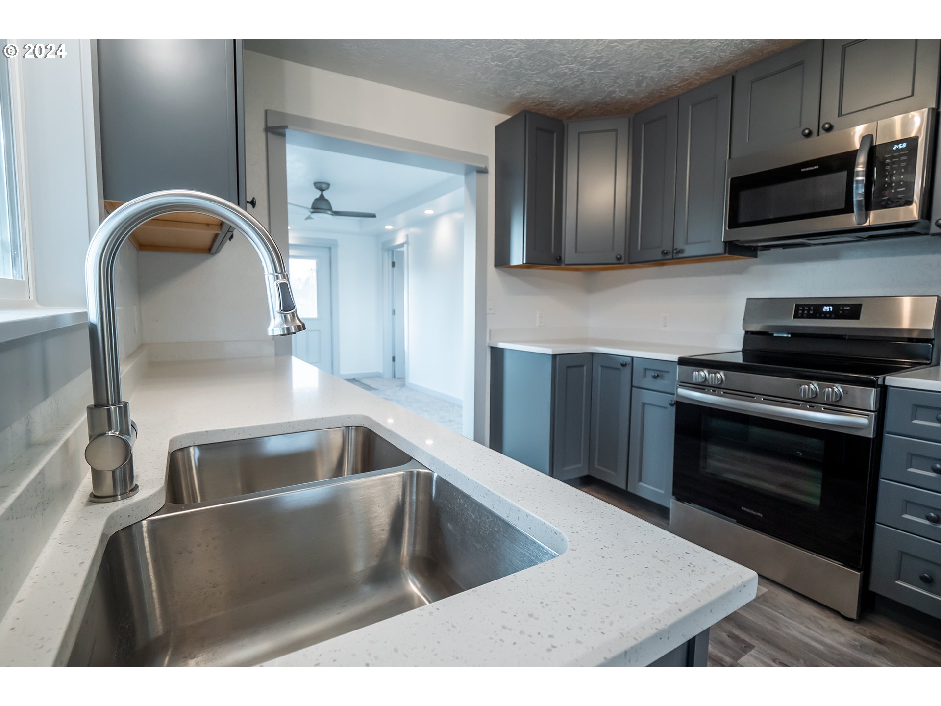 930 Elm Street Junction City, OR 97448 - Photo 6 of 33 a kitchen with stainless steel appliances wooden cabinets a sink and a stove