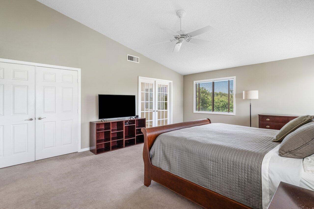11842 Island Lakes Lane Boca Raton, FL 33498 - Photo 36 of 49 a bedroom with a bed and a flat screen tv