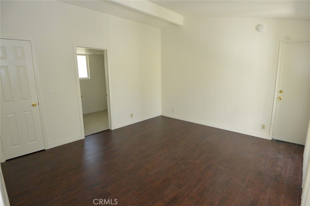 11392 Wallingsford Road Los Alamitos, CA 90720 - Photo 11 of 17 an empty room with wooden floor and windows