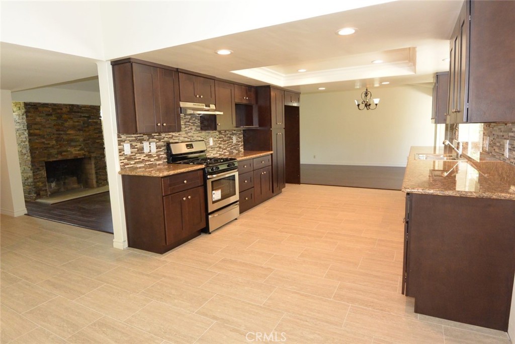 11392 Wallingsford Road Los Alamitos, CA 90720 - Photo 5 of 17 a kitchen with stainless steel appliances granite countertop a stove a sink and a refrigerator