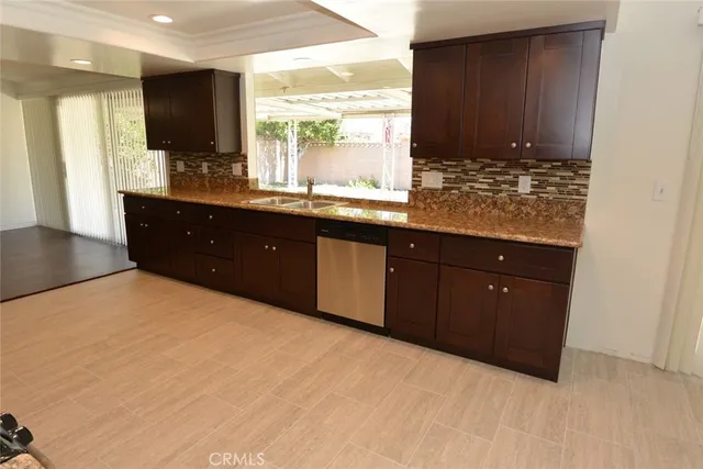 a kitchen with a sink window and cabinets