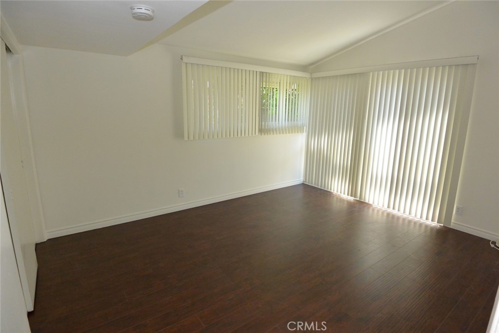 11392 Wallingsford Road Los Alamitos, CA 90720 - Photo 9 of 17 an empty room with wooden floor and windows