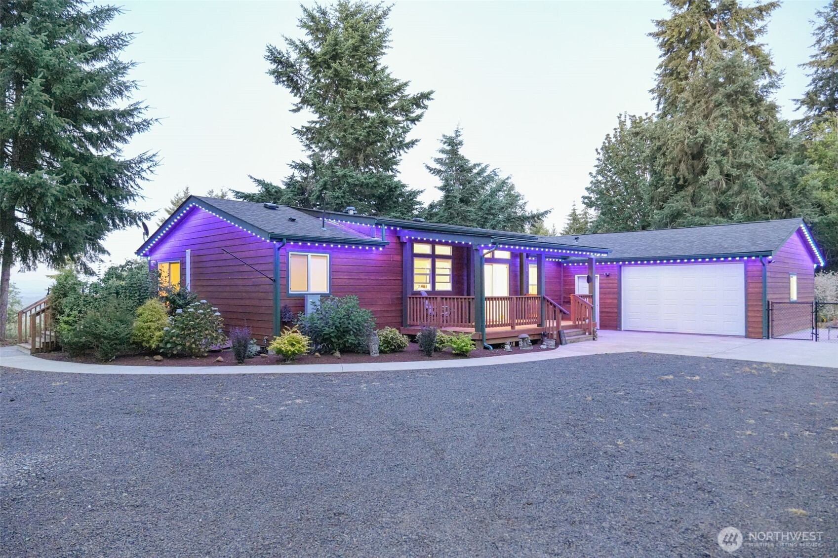 a view of a house with a yard and street