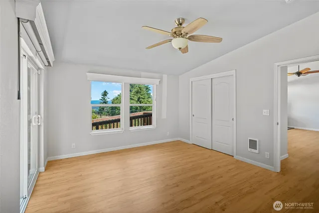 a view of empty room with wooden floor