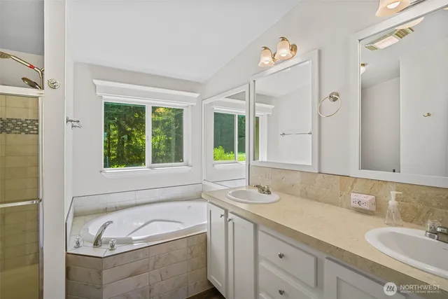 a bathroom with a tub and a shower