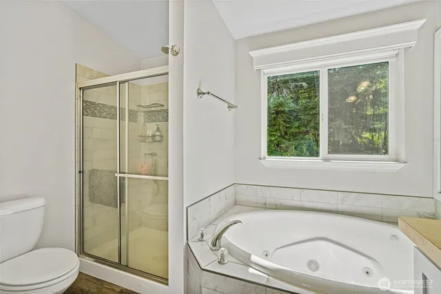 a view of a hallway with wooden floor and living room
