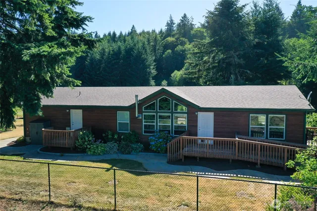 a view of a house with backyard and sitting area