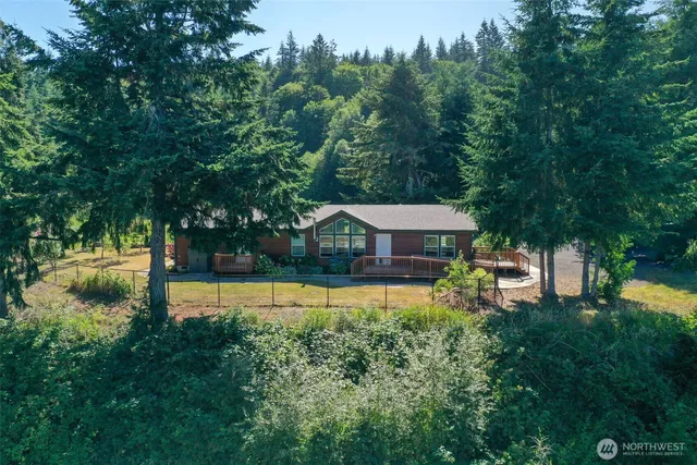 a view of a small house with a tree in front of it