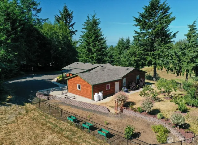 an aerial view of a house with yard swimming pool and outdoor seating
