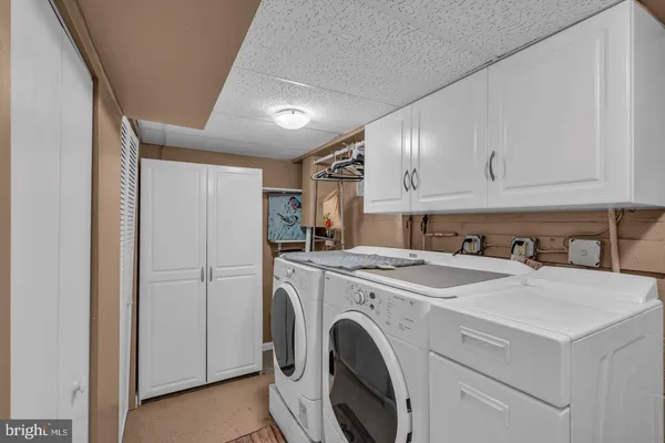 a view of washer and dryer with kitchen in the background
