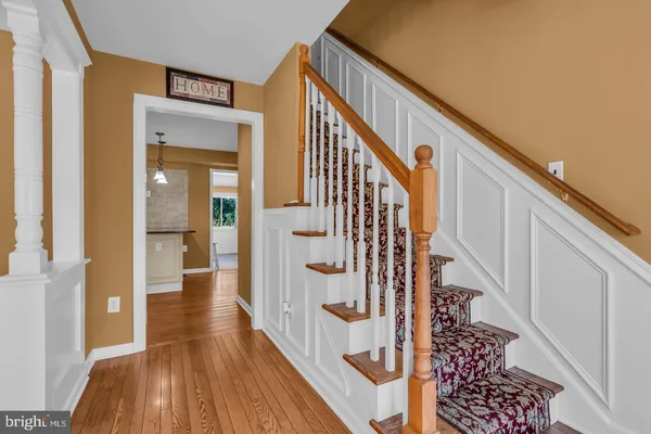 a view of entryway with wooden floor and stairs