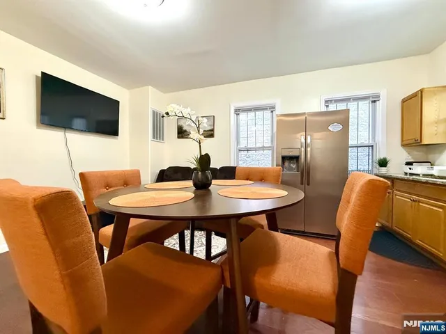 a view of a dining room with furniture and wooden floor