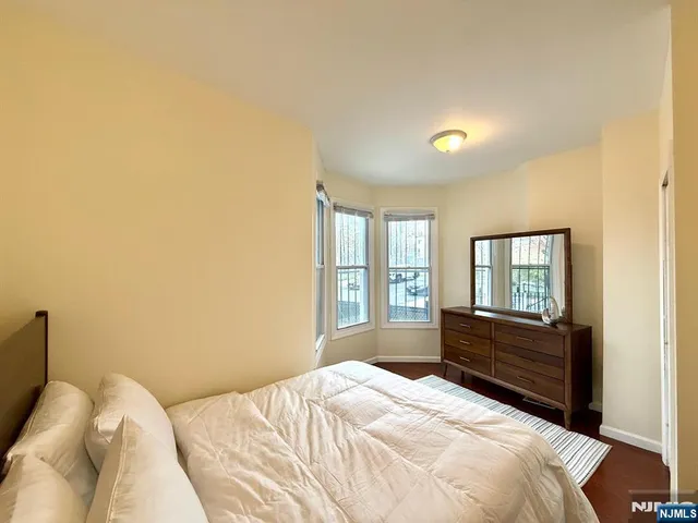 a bedroom with a bed and a large mirror