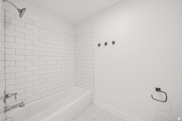 1002 West Temple Rim Lane Payson, UT 84651 - Photo 38 of 68 Bathroom featuring a white subway-tiled shower surround, a full bathtub with chrome fixtures, and a herringbone-patterned floor tile