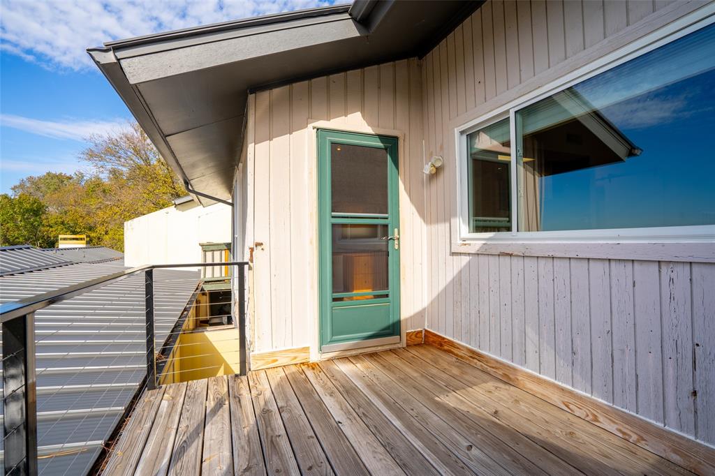 9999 Boat Club Road, Unit 207 Fort Worth, TX 76179 - Photo 14 of 32 a view of a balcony with wooden floor and staircase