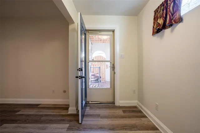 a view of a room with wooden floor and windows