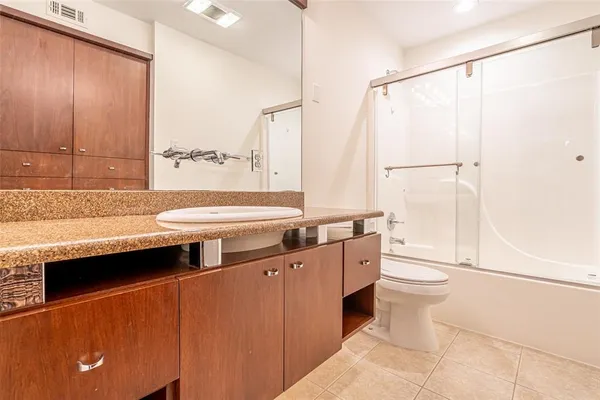 an empty room with a window and a ceiling fan