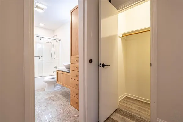 an empty room with a window and a ceiling fan