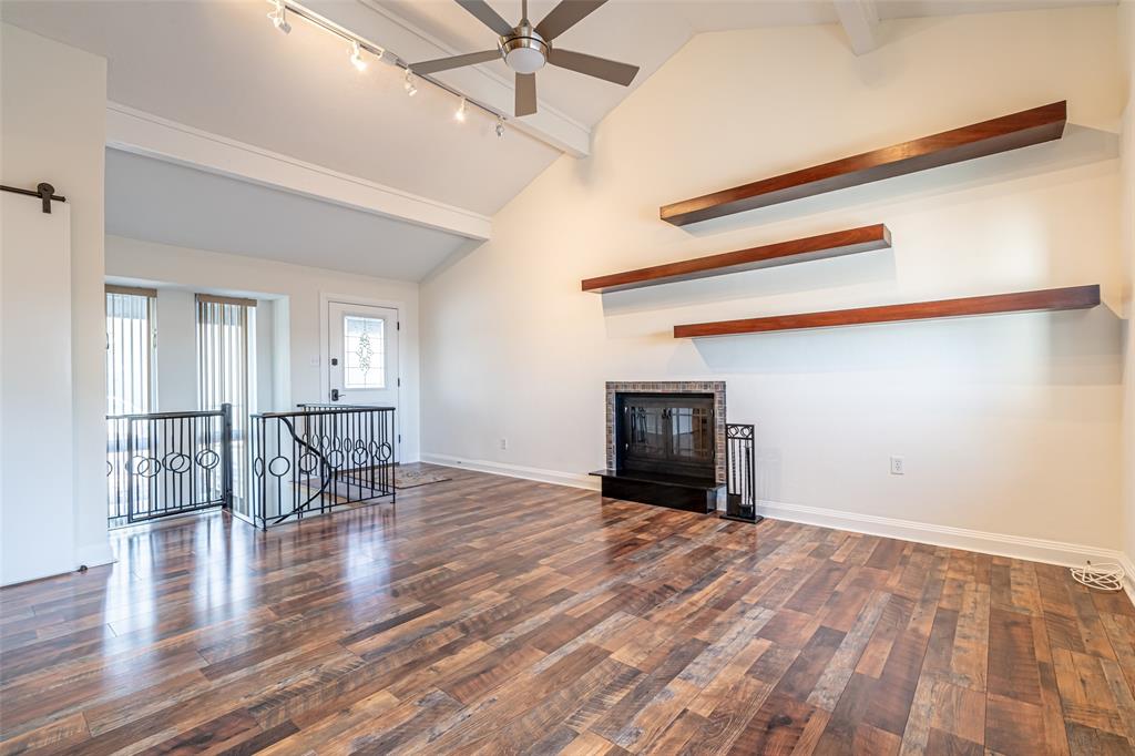 9999 Boat Club Road, Unit 207 Fort Worth, TX 76179 - Photo 3 of 32 a view of empty room with wooden floor and fireplace