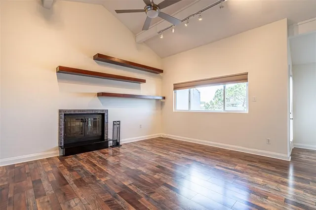 a kitchen with granite countertop stainless steel appliances a counter top space and a large window