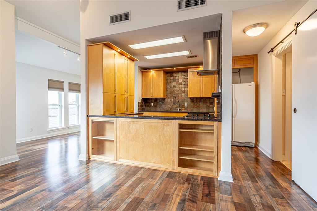 9999 Boat Club Road, Unit 207 Fort Worth, TX 76179 - Photo 5 of 32 a kitchen with granite countertop stainless steel appliances a counter top space and a large window