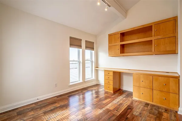 a view of a room with wooden floor and cabinet