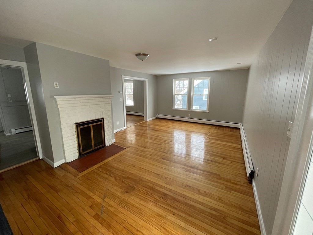 22 Rob Roy Road Worcester, MA 01602 - Photo 9 of 27 wooden floor in an empty room with a fireplace