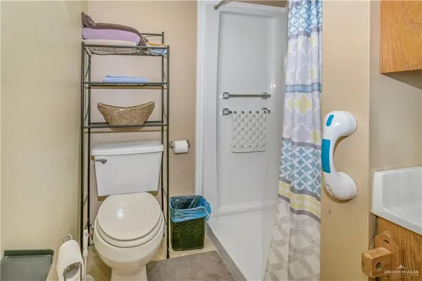 a bathroom with a toilet and a shower