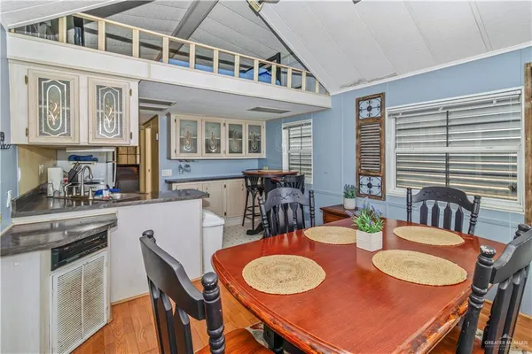 a dining room with furniture and wooden floor