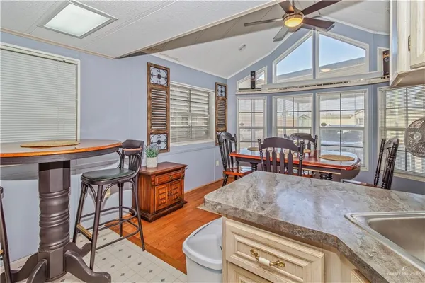 a living room with furniture a flat screen tv and large windows