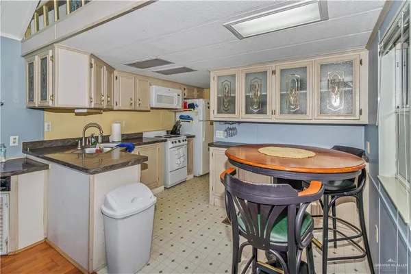 a kitchen that has a table and chairs in it