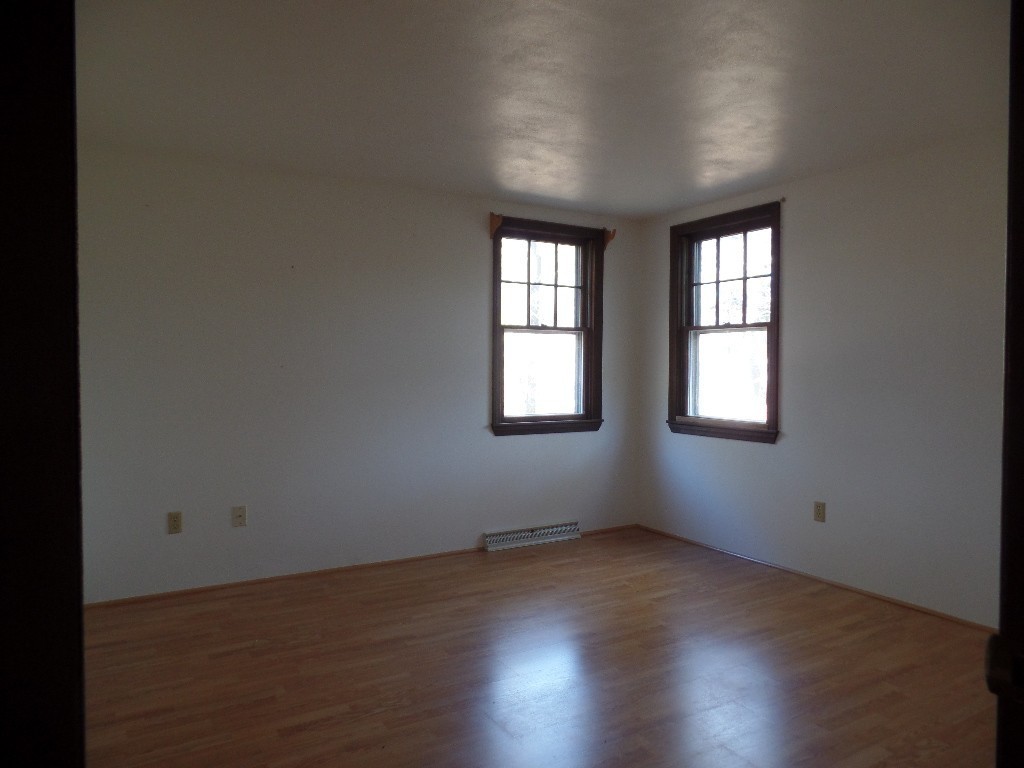 501 Walnut Plain Road Rochester, MA 02770 - Photo 8 of 8 an empty room with wooden floor and windows