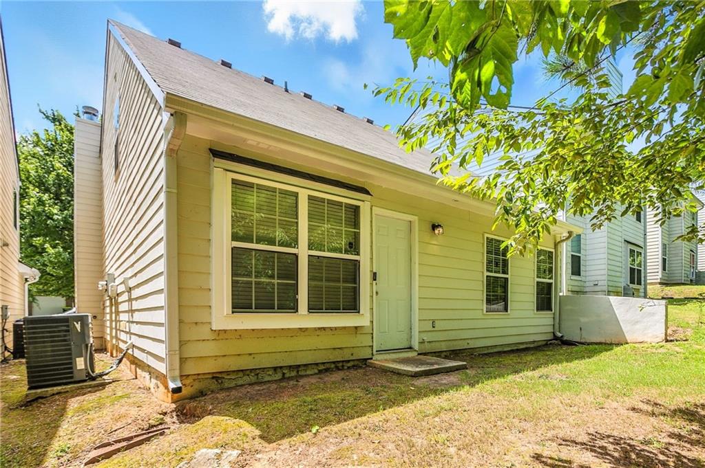 4611 Raven Wood Loop Union City, GA 30291 - Photo 19 of 24 a view of a house with a door and a yard