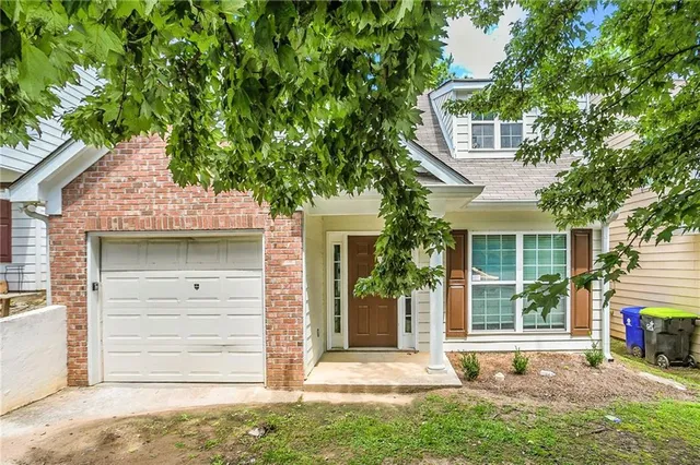 front view of a house with a tree