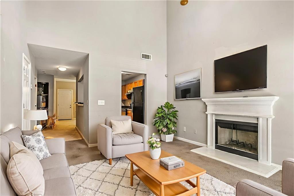 4611 Raven Wood Loop Union City, GA 30291 - Photo 4 of 24 a living room with furniture a flat screen tv and a fireplace