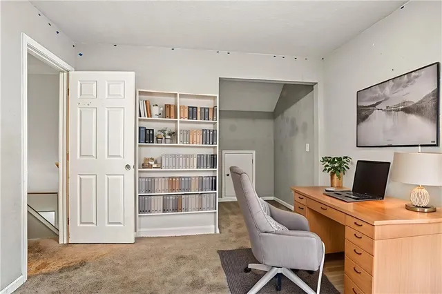 a view of a workspace with furniture and cabinet