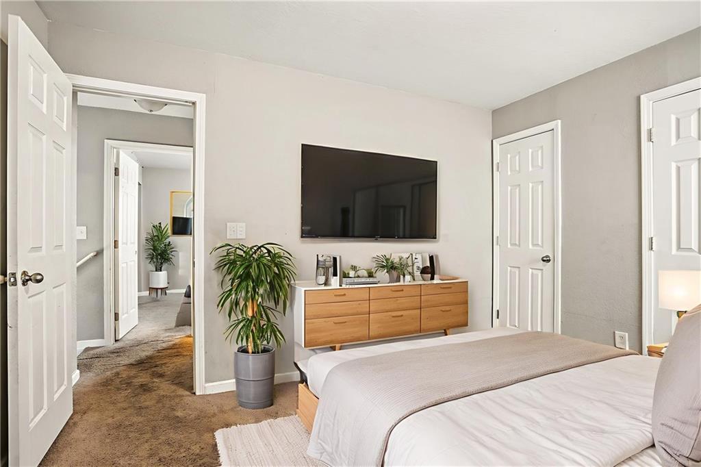 4611 Raven Wood Loop Union City, GA 30291 - Photo 7 of 24 a bedroom with a bed and a flat screen tv