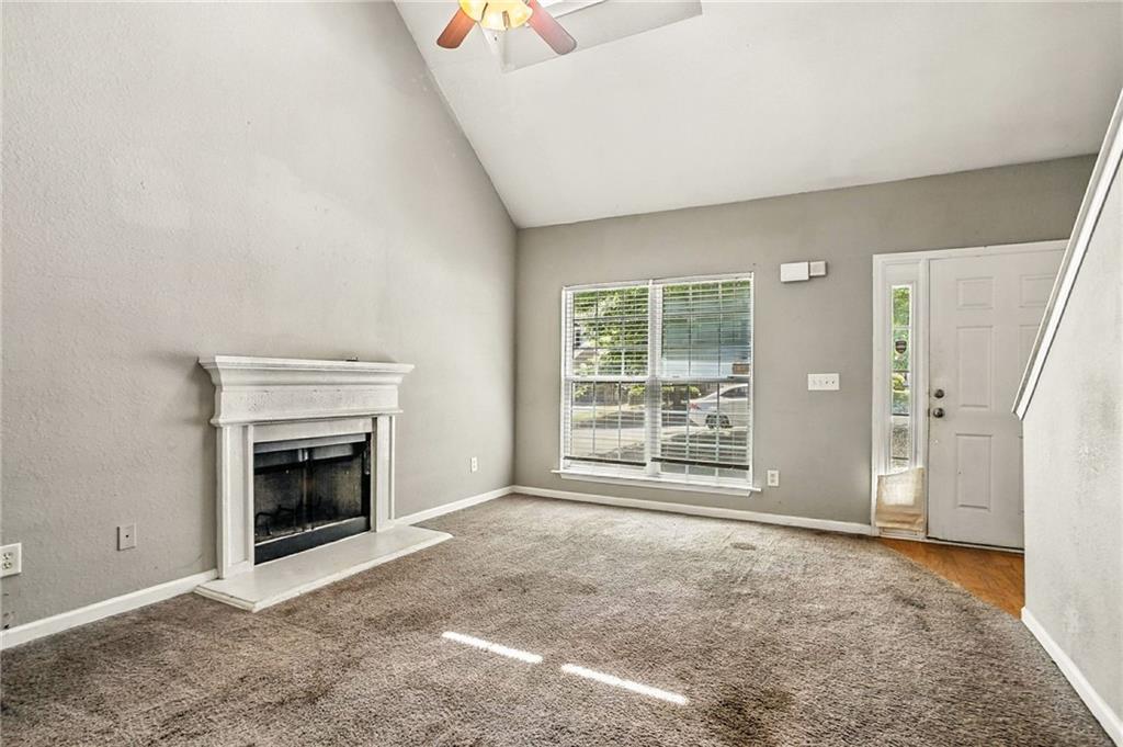 4611 Raven Wood Loop Union City, GA 30291 - Photo 9 of 24 a view of an empty room with a fireplace and a window