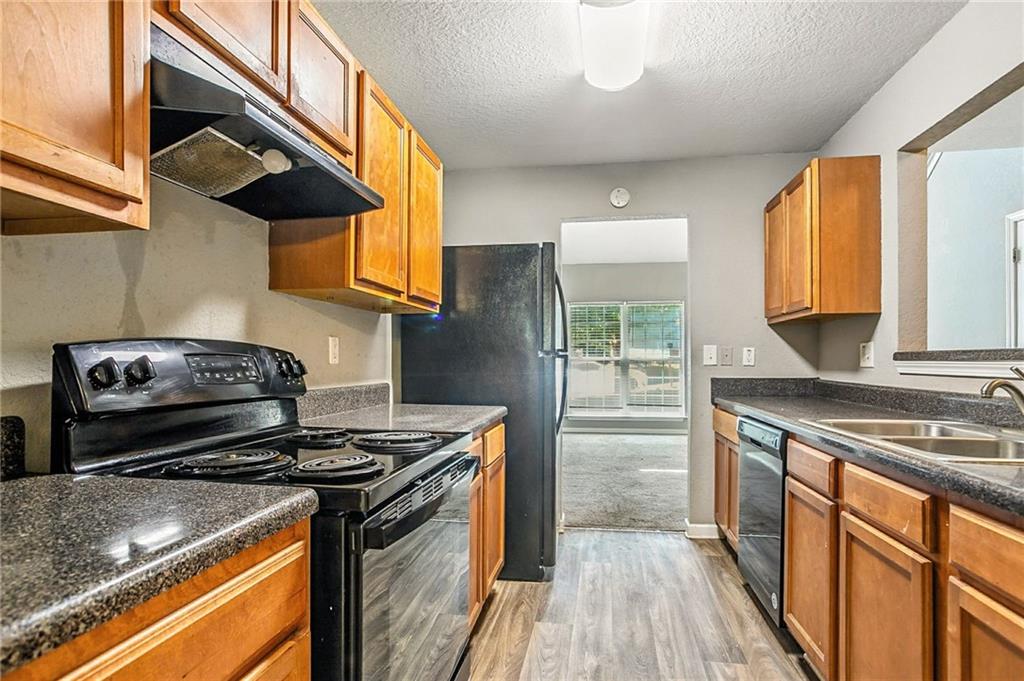 4611 Raven Wood Loop Union City, GA 30291 - Photo 10 of 24 a kitchen with a stove and a microwave